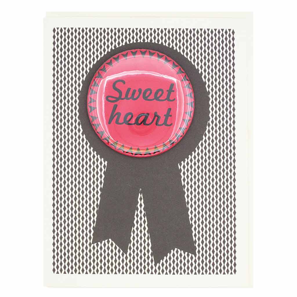 This card is sure to please your sweetheart. Features a 2¼” button that says "Sweet Heart" that can be taken off and proudly worn by the recipient. Card measures 4¼” x 5½”, comes with a cream envelope & is blank inside.